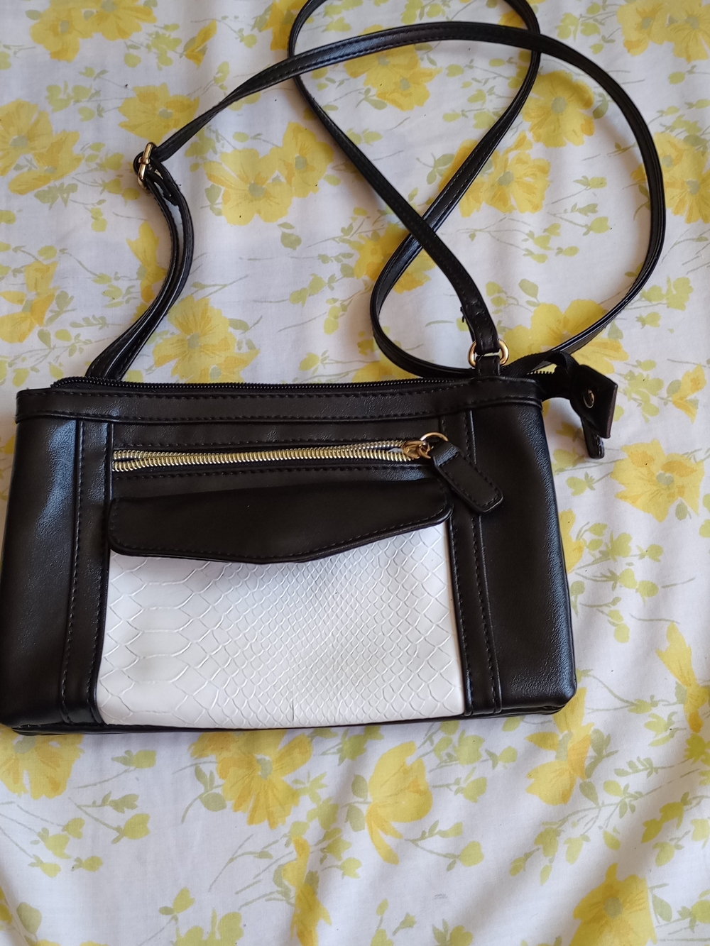 Yik Fung faux leather crossbody bag a distinct white textured pocket and an adju